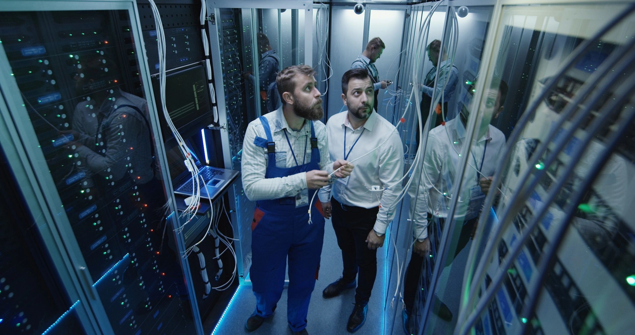 Voice and data network professionals in a server room